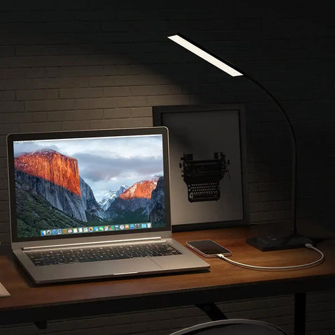 Dope LED Desk Lamp With USB Charging Port illuminating a desk with laptop, Eye-Caring Light for Dorm, Office, and Bedroom.