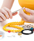 Person using All In One Jewelry Making Kit With Fifteen Jewelry Findings, Brass Ring, Beading Wires, Pliers And Tweezers