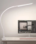 Ultra Versatile LED Desk Lamp With Clamp, Flexible Gooseneck next to computer monitor on white desk