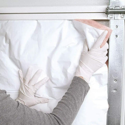R8 Fiberglass Garage Door Insulation Kit Fits Nine Foot Entries Blocks Street Noise And Knocks Out Chilling Drafts No Sweat Slide In Install shown being installed by hand.