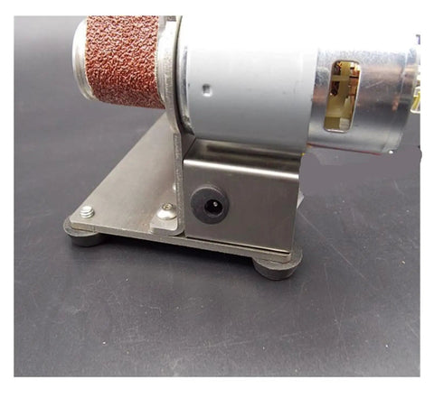 Compact Mini Electric Belt Sander And Multifunctional Desktop Grinder Workhorse For Diy Woodworkers showing metal base, motor, and sanding belt.