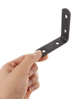 Hand holding Black Stainless Steel Corner Bracket from 12 Pack L Shaped Right Angle Braces for Furniture and Cabinet Shelves