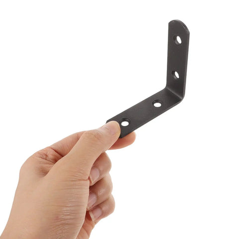 Hand holding Black Stainless Steel Corner Bracket from 12 Pack L Shaped Right Angle Braces for Furniture and Cabinet Shelves