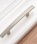 Close-up of 20 Pack 3 Inch Brushed Nickel Kitchen Cabinet Pulls Satin Silver Handles For Cabinets And Furniture Smooth Rounded Corners Prevent Snags Easy Grip Beefy Solid Metal Hardware For Kitchen Bedroom Dresser Cupboard on white drawer