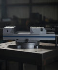 Heavy-Duty Combination Flat Vise Machine Precision Milling Tool Low Play Setup Wear Resistant Base For Machining Centers on a workshop table.