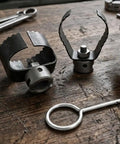 Heavy Duty Three Piece Drain Auger Set Featuring Tough As Nails Steel Cutter Heads For Knocking Out Grease And Hair Clogs In 4 Through 8 Inch Pipes tools on wooden surface