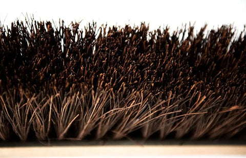 Close-up of bristles on Heavy Duty 18 Inch Palmyra Bristle Push Broom For Garage Indoor Floor Sweep Top Shelf Wooden Block.