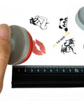 Zero Fuss Self Inking Craft Stamp Showing A Vintage Blank Clock Dial Design For Scrapbooking And Journal Projects That Amps Up Your Creative Flow With Super Clean Prints Every Time, with a hand holding the stamp.