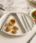 Beefy All Metal Nutcracker Tool For Cracking Nuts Lobster Claws Crabs And Tough Shells, zinc frame on white plate with walnuts
