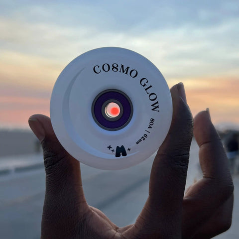 Cosmo Glow LED Outdoor Roller Skate Wheel held at sunset, 62mm x 32mm size, White Rain Glow with Bright Light Up Illumination