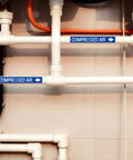 Economy 1 Roll Pipe Markers For Compressed Air Lines, 1 Inch High By 8 Inch Wide, Self Adhesive White And Blue Labels, Easy Peel And Apply, Durable Plastic Film Identification For Piping Systems on white PVC pipes