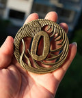Hand Forged Alloy Katana Tsuba Guard With Aquatic Pattern 3.2 Inch Authentic Iaido Accessory shown on open palm