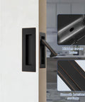 Slick Recessed Pocket Door Hardware Set With Flushing Edge Pull And Two Legit Heavy Duty Slide Handles For Smooth Closet Barn Door Operation In Top Shelf Oil Rubbed Bronze Finish on a door.