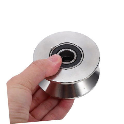 Heavy Duty Stainless Steel U Groove Sliding Door Roller Pulley With Ball Bearings held in hand, designed for seamless sliding on tracks.