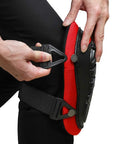Person adjusting Knee Pads For Work With Soft Gel Core And EVA Foam Padding, ergonomic design in red and black with adjustable straps