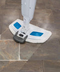 Front view of BonusLife steam mop pad attached to Bissell PowerFresh mop head; white pad with blue patches.