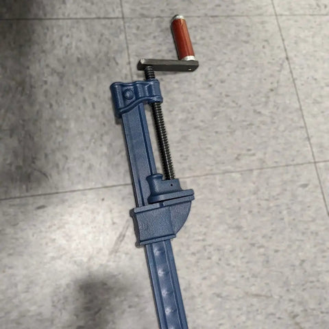 Heavy Duty I Bar Clamp Four Foot Length With Throat One And Thirteen Sixteenths Inches And Clamp Face One And Seven Eighths Inches Six Thousand Lbs Clamping Force Rapid Acting No Slip Clutches For Everyday Woodworking And Fabrication Workhorse steel bar clamp on floor