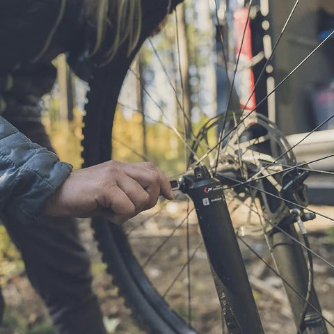 Using the Lockdown Driver 7 In 1 EDC Multitool With A 2.5 Inch Plain Edge Blade on a bicycle wheel outdoors
