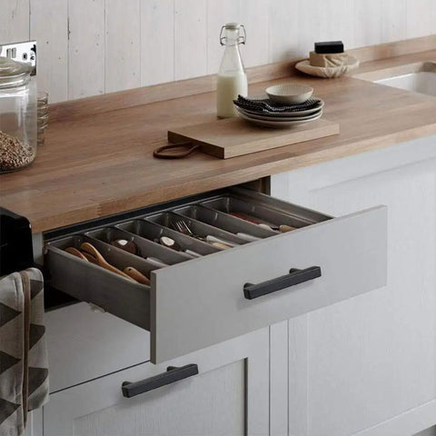 Open kitchen drawer with 3 Inch Black Cabinet Hardware Set pull, showing silverware organizer; modern kitchen setup.