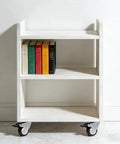 Dead Silent TPR Rubber Swivel Casters With Parking Brake Lock support a white bookshelf with books, ideal for easy movement.