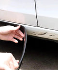 Person installing Premium Solid Rubber Car Skirt Guard Strip For Tesla Cybertruck to lower panel for protection.