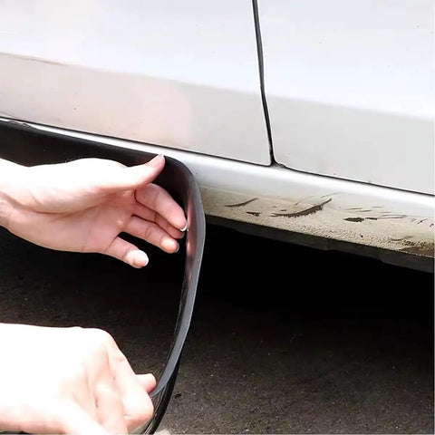 Person installing Premium Solid Rubber Car Skirt Guard Strip For Tesla Cybertruck to lower panel for protection.