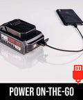 PWR CORE 20 2.0Ah battery from Beast Mode Cordless Jigsaw Kit With USB charging a smartphone, showcasing portability.