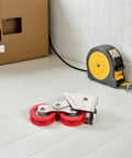 Real Deal Heavy Duty Sliding Door Rollers With Dual Wheel Setup Rock Solid Stainless Steel Build And Super Smooth Glide Operation For Patio Garage Door Track Replacement Hardware on a workspace floor.