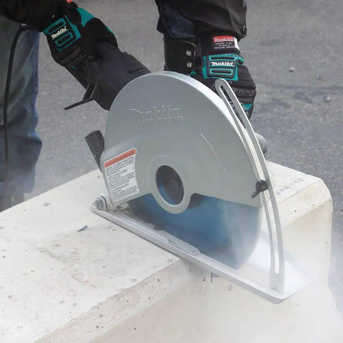 14 Inch Electric Angle Cutter Powered By A Rugged Fifteen Amp Motor And Smart Slip Clutch Design To Save Your Gears cutting through concrete block.