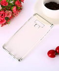 Clear smartphone case with open cutouts on a white surface surrounded by flowers, coffee cup, and cherries