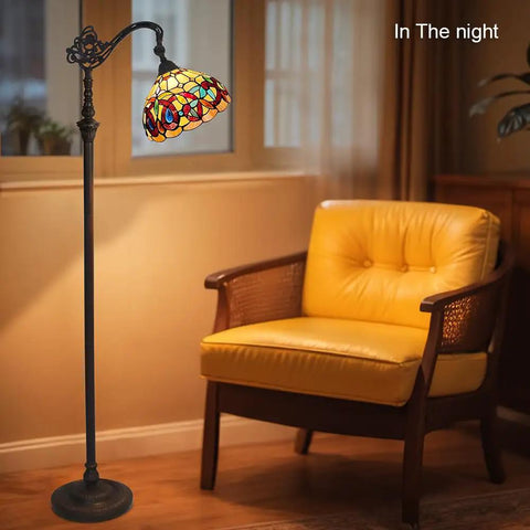 Stained Glass Tiffany Style Floor Lamp Standing 62 Inches Tall With Inlaid Crystal Accents beside yellow chair in living room