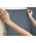 Applying Navy And Gray Twig Hygge Herringbone Peel And Stick Wallpaper For Easy Rental Makeovers 20.5 Inch Wide By 16.5 Feet Long No Water No Mess 100 Percent Removable On Smooth Surfaces to wall.