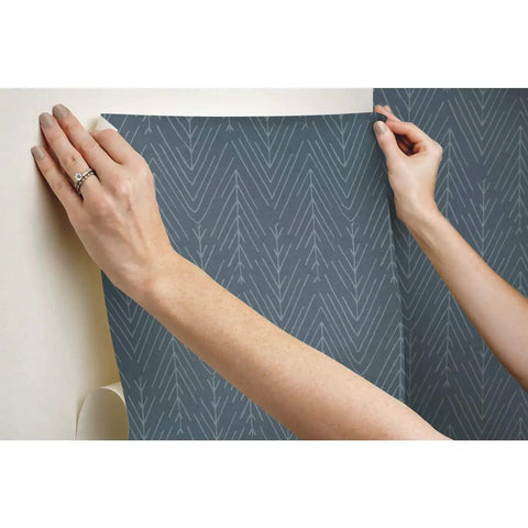 Applying Navy And Gray Twig Hygge Herringbone Peel And Stick Wallpaper For Easy Rental Makeovers 20.5 Inch Wide By 16.5 Feet Long No Water No Mess 100 Percent Removable On Smooth Surfaces to wall.
