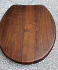 Solid Heavy Duty Elongated Toilet Seat With No Sweat Soft Close Lid And Quick Release Stainless Steel Hinges In Rich Black Walnut Wood top view.