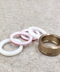 Seal assembly: brass HP waterjet ring with four white and pink elastomer O-rings