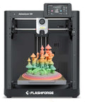 Beginner Friendly Adventurer 5M 3D Printer With Auto Leveling And Direct Drive showcasing rainbow 3D printed castle model.