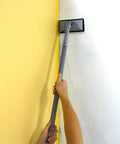 Applying paint with Emulsion Paint Pad Kit 9 Piece Set For Walls And Ceilings With Extension Poles in corner, smooth finish visible