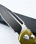 Close-up of the serrated blade of the Beefy 7.9 Inch Button Lock Folding Pocket Knife with D2 Steel on black background.