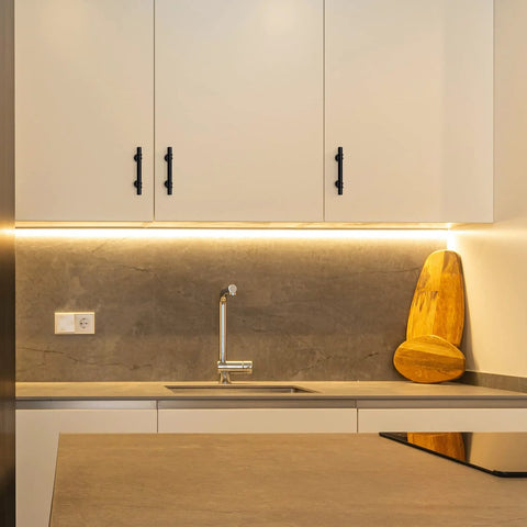 Modern kitchen with white cabinets featuring 30 Pack 5 Inch Matte Black Cabinet Pulls With Round Base For Kitchen Cabinets And Drawer Fronts.