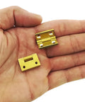 Gold hinges from Self-Closing Reversible Door Hinge Set, 10 Pieces, 19 By 12.5mm, 4-Hole Butt Hinges for Cabinets and Jewelry Boxes in hand