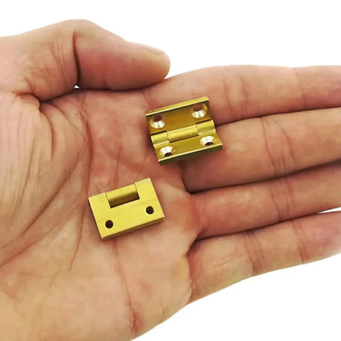 Gold hinges from Self-Closing Reversible Door Hinge Set, 10 Pieces, 19 By 12.5mm, 4-Hole Butt Hinges for Cabinets and Jewelry Boxes in hand