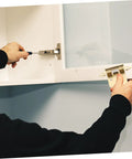 Mobestech spring-loaded cabinet hinge for RV/camper - installation view; silver metal hinge on white cabinet.