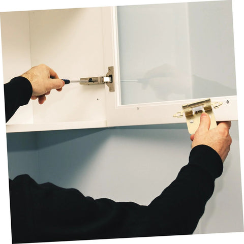 Mobestech spring-loaded cabinet hinge for RV/camper - installation view; silver metal hinge on white cabinet.