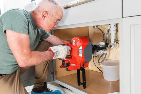 Heavy Duty Cordless Drain Snake With Brushless Motor and Twenty Five Foot Steel Cable Blasts Away Stubborn Clogs fast under sink use.