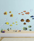 Under The Sea Fish Wall Sticker Set Peel And Stick Decor for kids, featuring colorful fish and bubbles, on a blue wall.