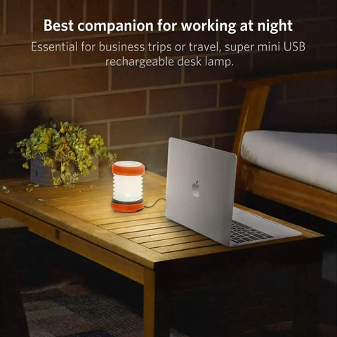 USB Rechargeable Camping Lantern With Hand Crank on table beside laptop for patio garden and night hiking