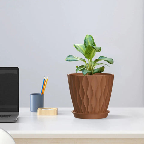4 Inch Small Plastic Nursery Pots Set Of Five With Drainage Holes And Saucers Water Ripples 3D Wave Design shown on desk
