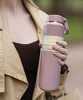 Person holding an Insulated Leakproof Stainless Steel Water Bottle 24 Oz Vacuum Hydration Flask For Sports Hiking Travel And Daily Use