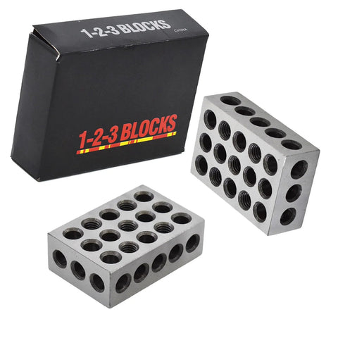 Two gray metal 1 x 2 x 3 inch parallel blocks with 23 holes each for milling setups.