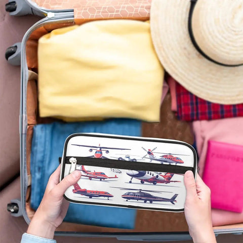 Hands holding Go To Travel Toiletry Bag For Women And Men Foldable Dopp Kit with aircraft pattern next to packed suitcase